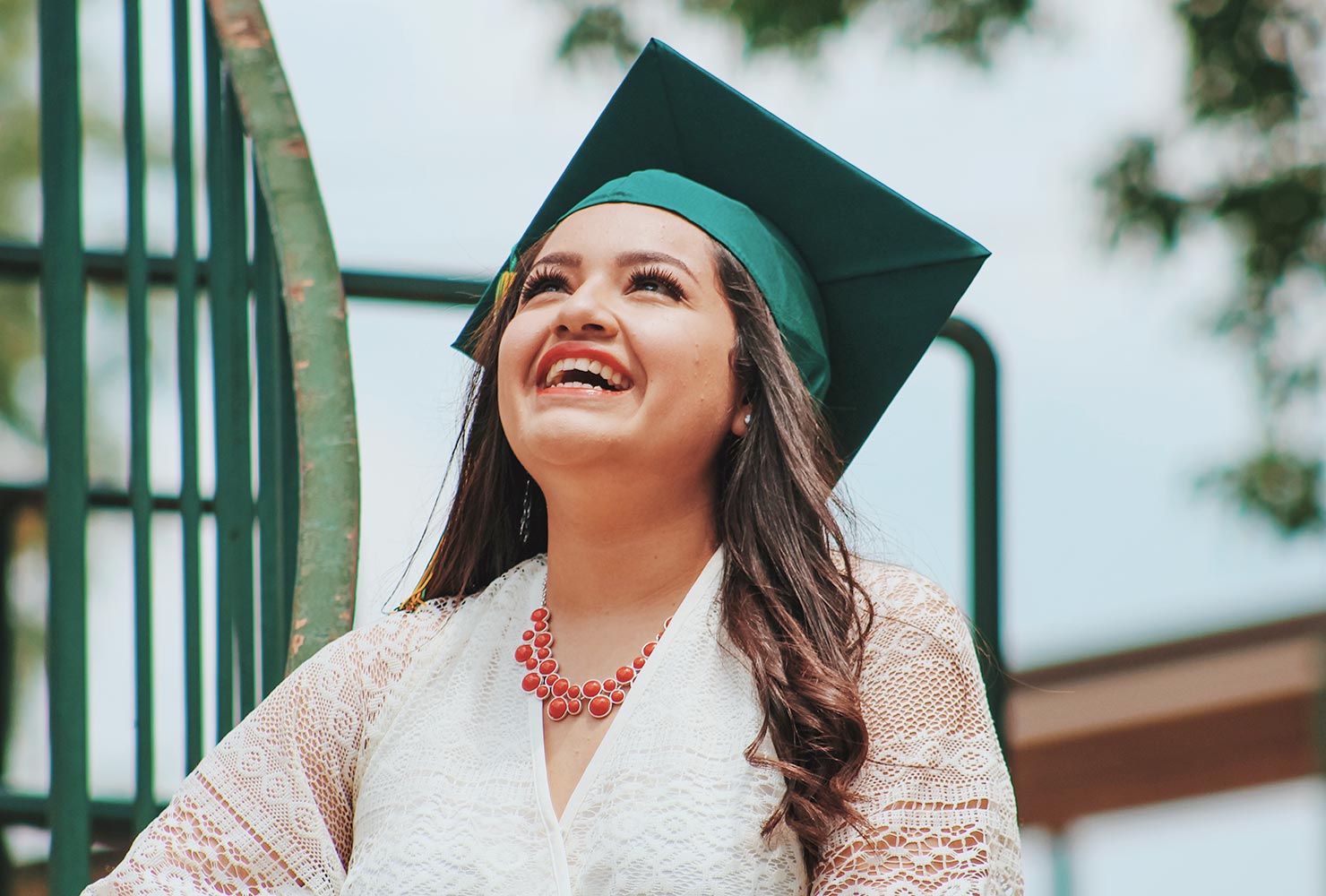 Girl graduate smiling with green cap