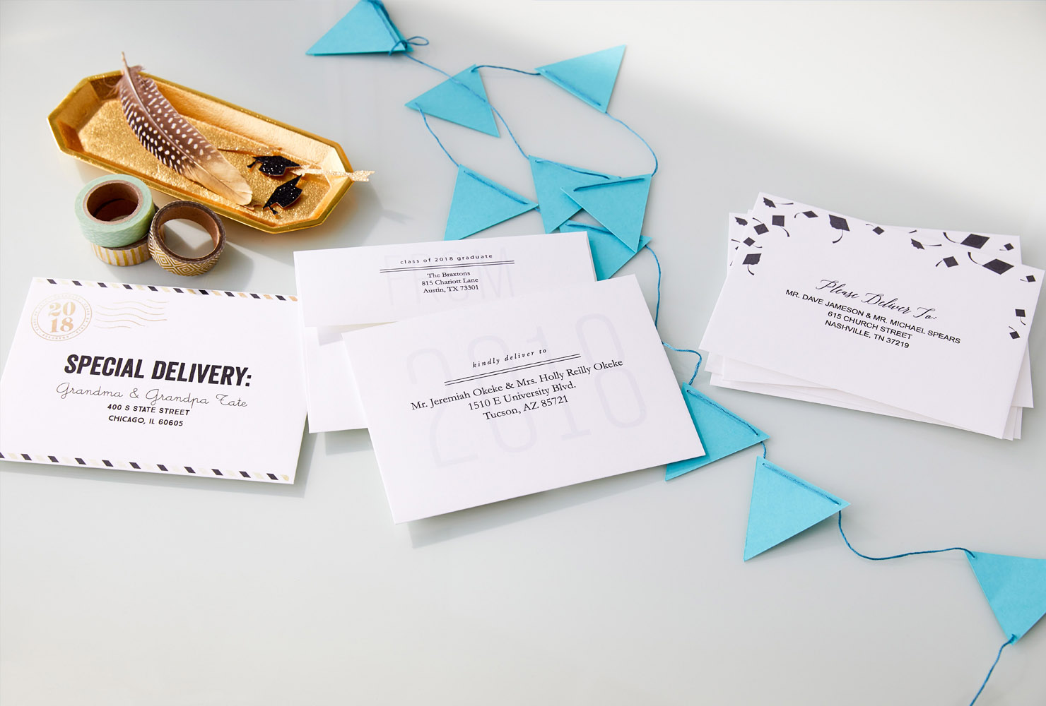 Desk of graduation cards and envelopes with blue banner