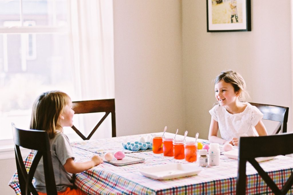 Kids decorating crafts at the kitchen table during the Easter holiday