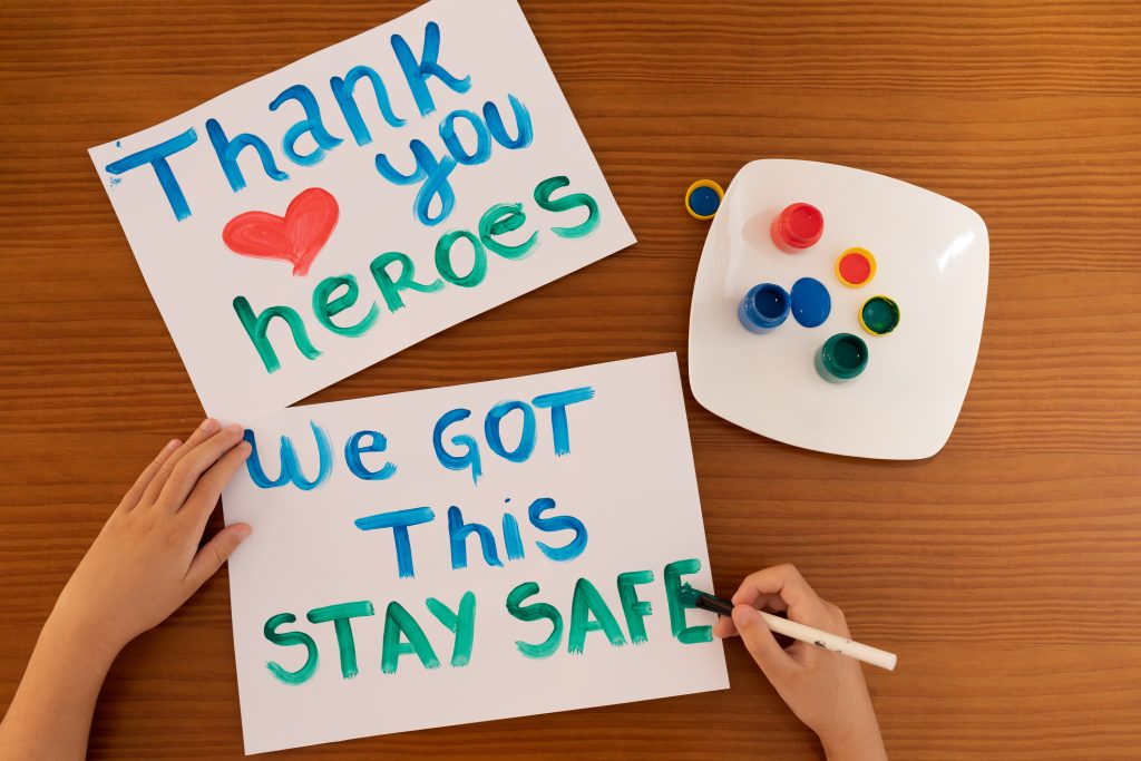 Close up hand of child making positive messages to frontline heroes working during Coronavirus (COVID-19) quarantine.