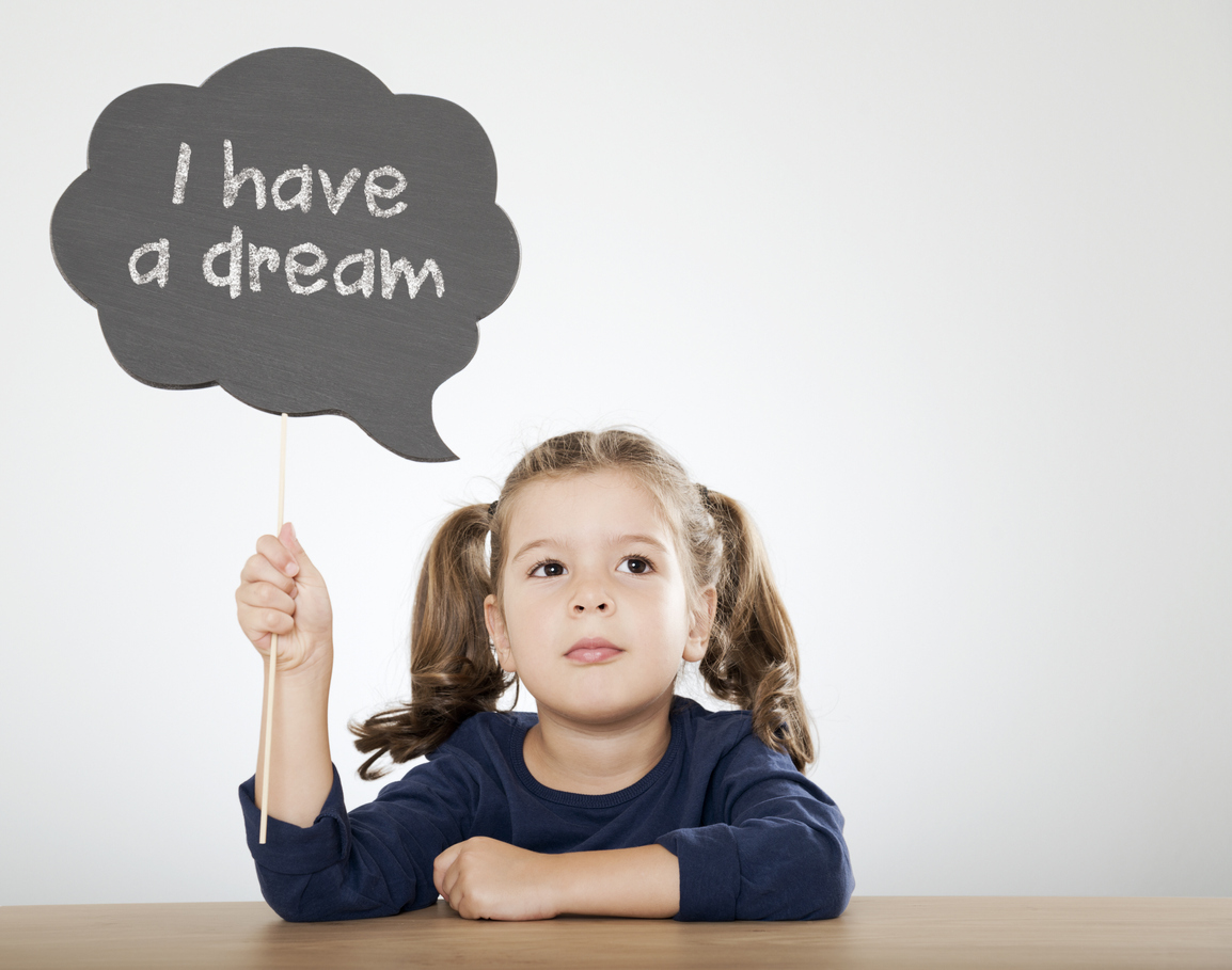 little girl holding "I have a dream" written speech bubble