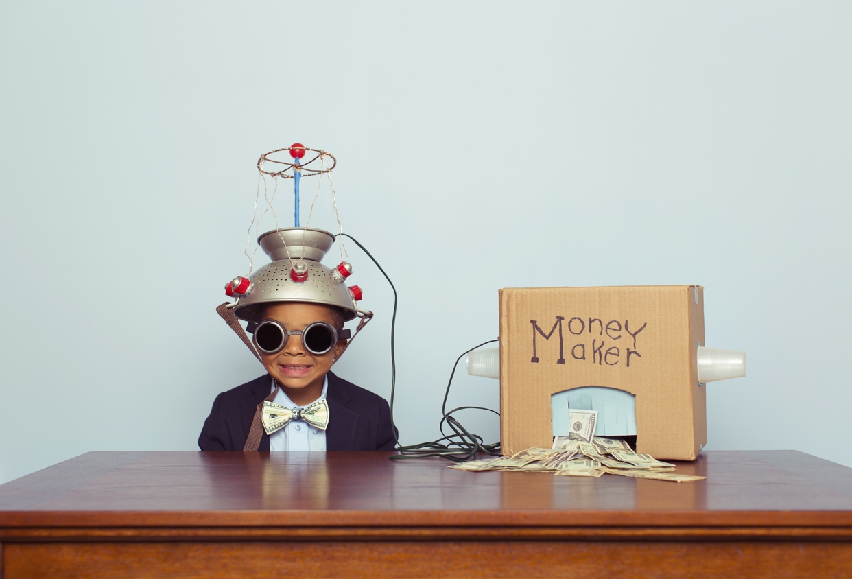 Young Business Boy wearing Mind Reading Helmet Makes Money